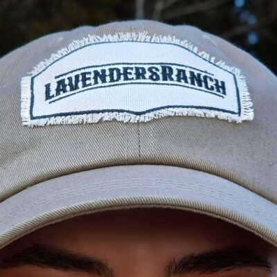 A close-up of a Cowgirl wearing the Original Cap in Light Khaki.