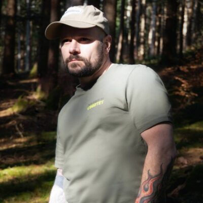 A cowboy wearing the Powered By Country T-Shirt in Khaki