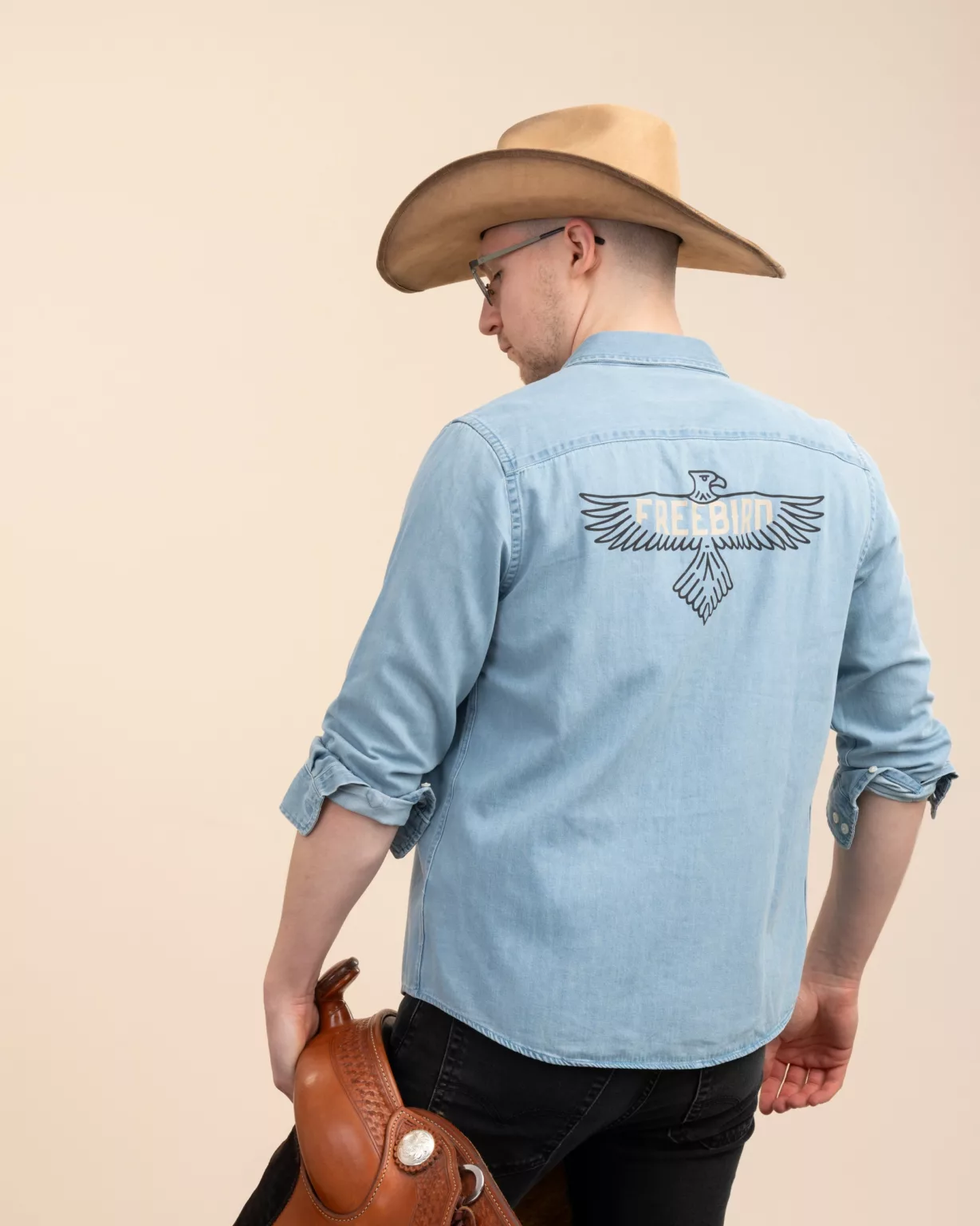 Rückansicht des leichten Unisex-Denim-Shirts von LavendersRanch (LR) mit dem Freebird-Aufdruck auf dem Rücken, hergestellt aus GOTS-zertifizierter Bio-Baumwolle im Western-Country-Stil.