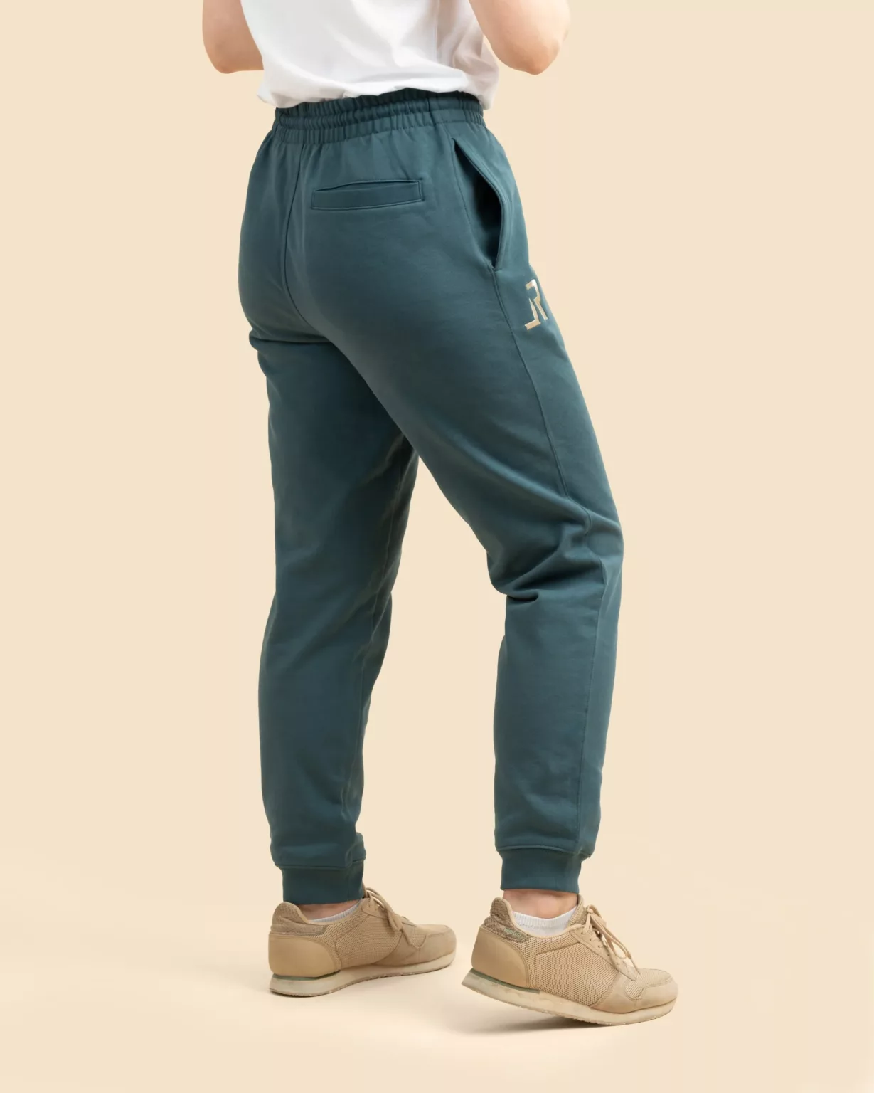 Back view of sustainable teal blue sweatpants with side pockets and embroidered logo by LavendersRanch (LR), perfect for casual outdoor lifestyle.