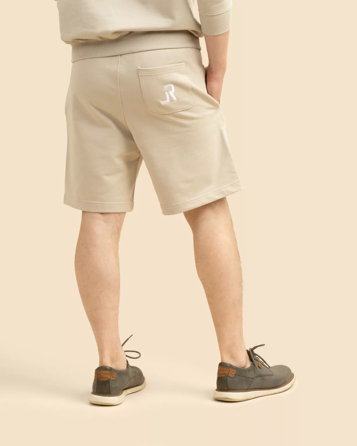 Back view of unisex beige desert shorts with embroidered LavendersRanch (LR) logo, made from sustainable organic cotton.