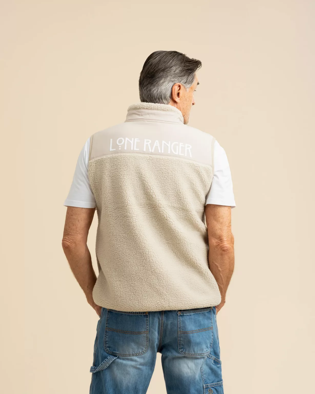 Man wearing a sustainable teddy vest from LavendersRanch (LR) with "Lone Ranger" printed on the back. The vest is made from 100% recycled polyester, embodying western style and conscious fashion.