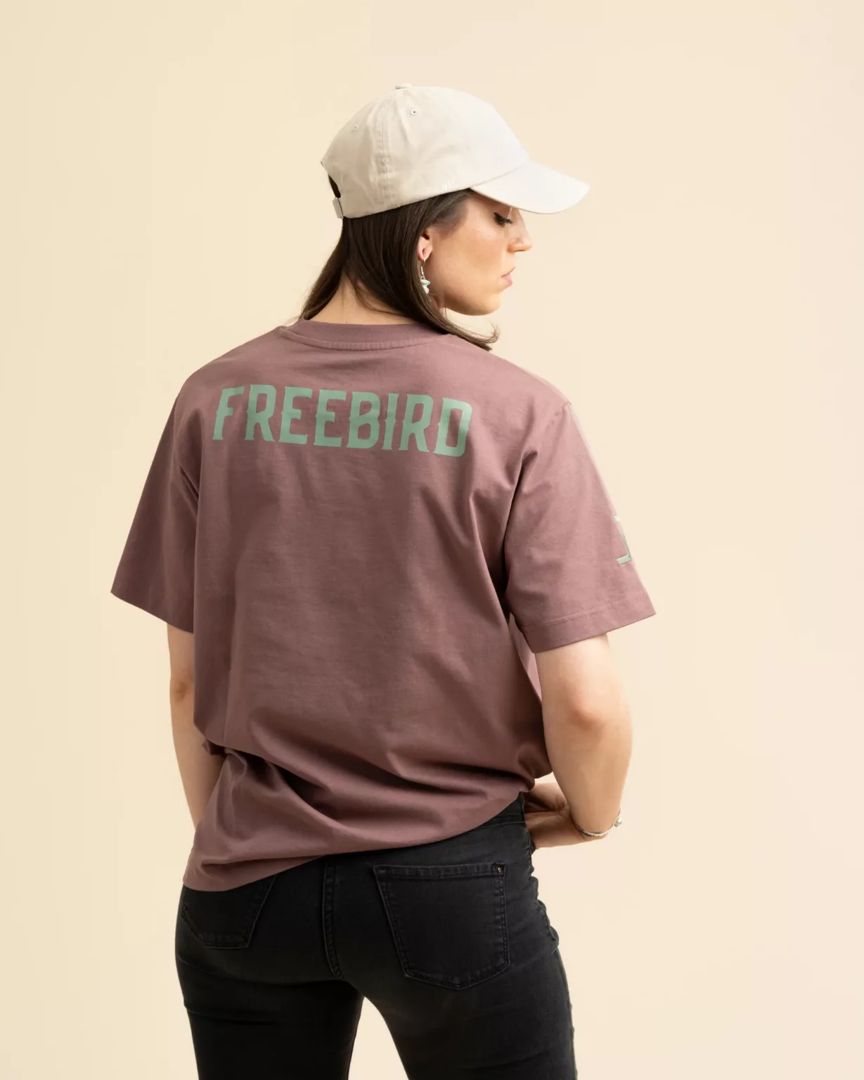The back view of the Rosewood Heavy T-shirt from LavendersRanch (LR), featuring a bold "Freebird" print, sustainably produced and designed in Western style.